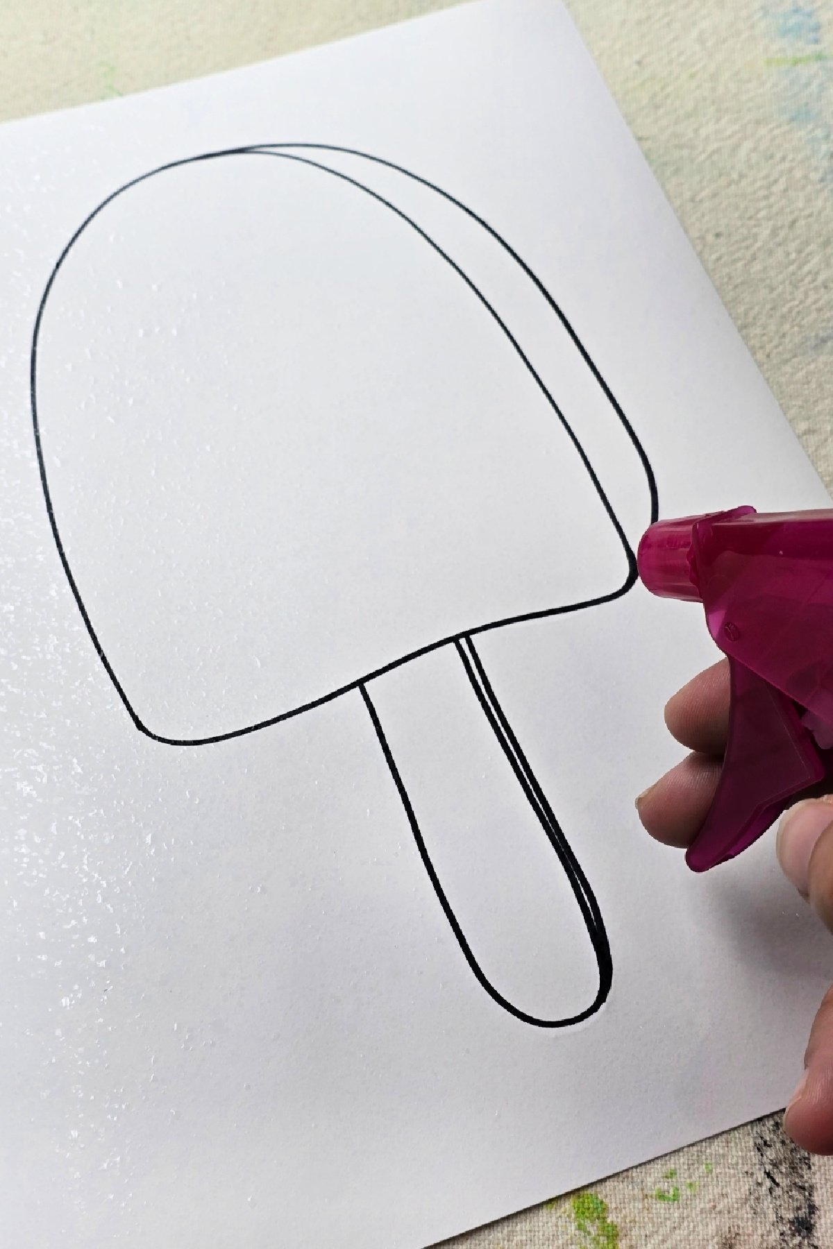 step 4 - spraying paper with clean water - kids activities blog