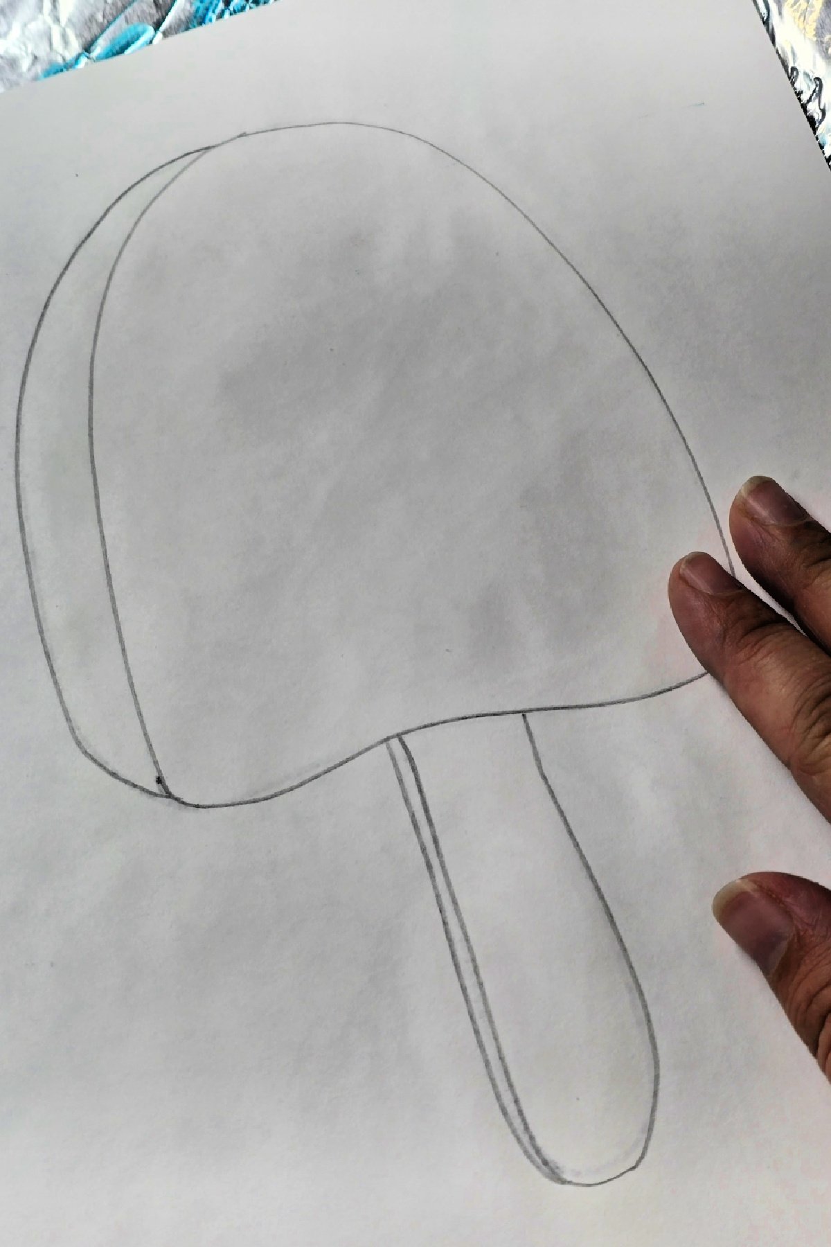 step 5 - pressing wet cardstock to colored aluminum foil - kids activities blog