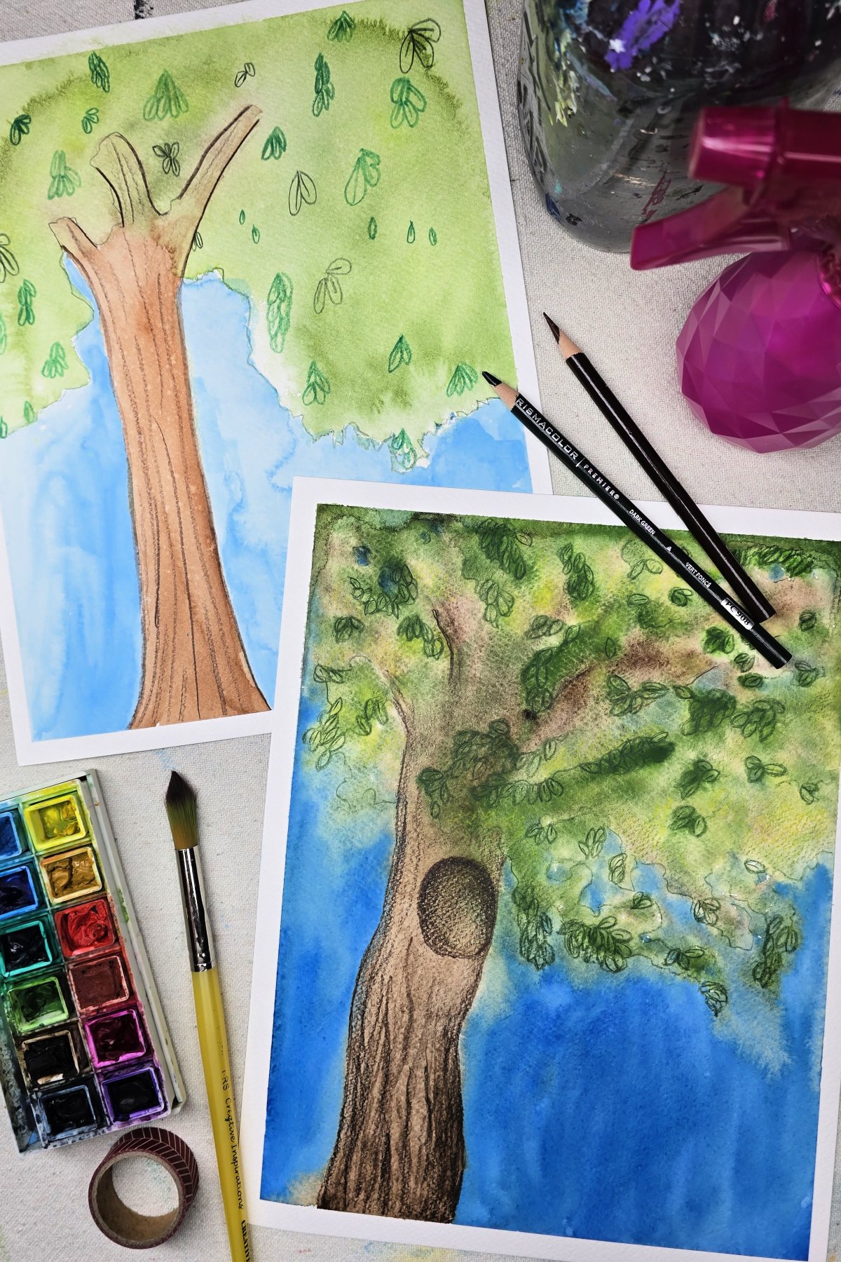 completed tree paintings using watercolors and colored pencils - kids activities blog