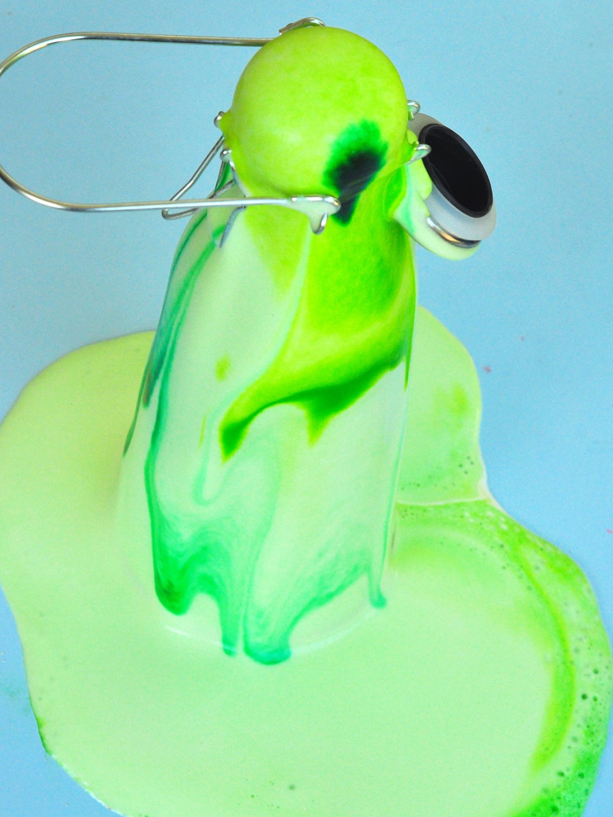 Science Experiment Completed- green mixture overflowing from bottle- kids activities blog