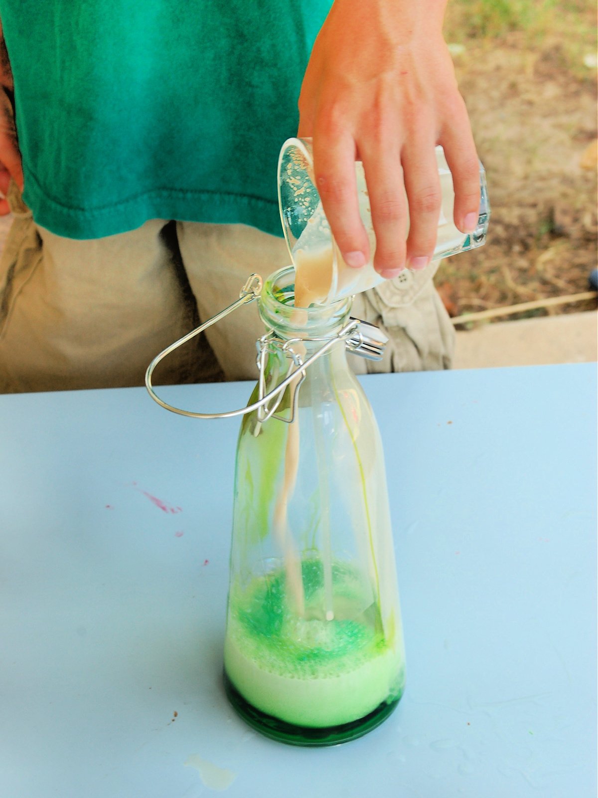Science Experiment- step 4- add yeast to green mixture- kids activities blog