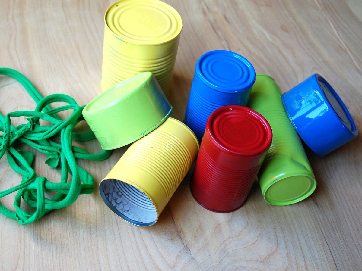DIY Wind Chime Craft- Step 2 - Painted wind chimes on a wood floor with green string- Kids Activities Blog