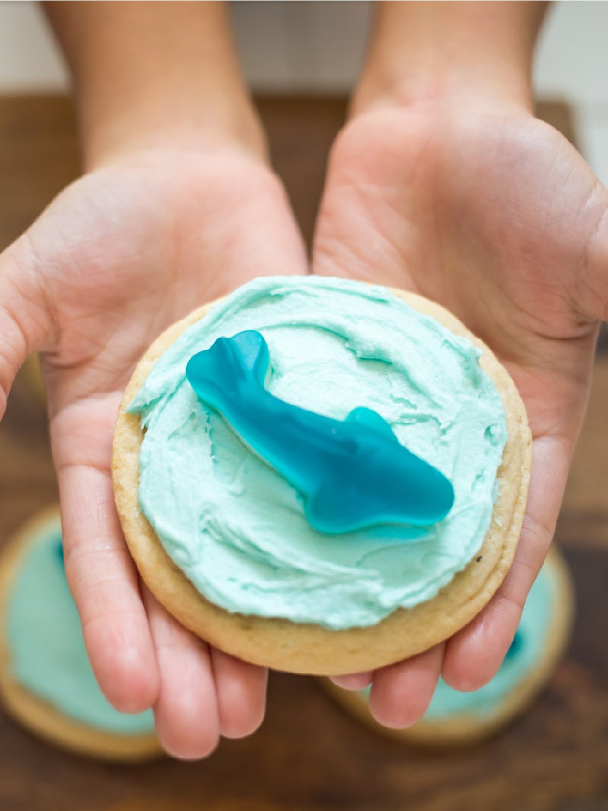 Shark Week Food- Sugar cookie with blue frosting and gummy shark-Kids Activities blog