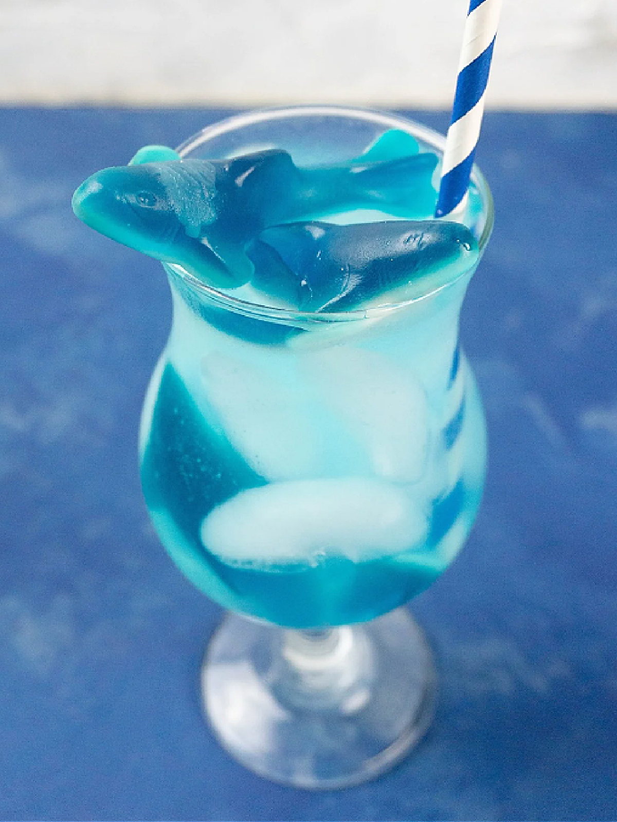 Shark Drink- Blue drink with ice in a glass with gummy sharks- kids activities blog