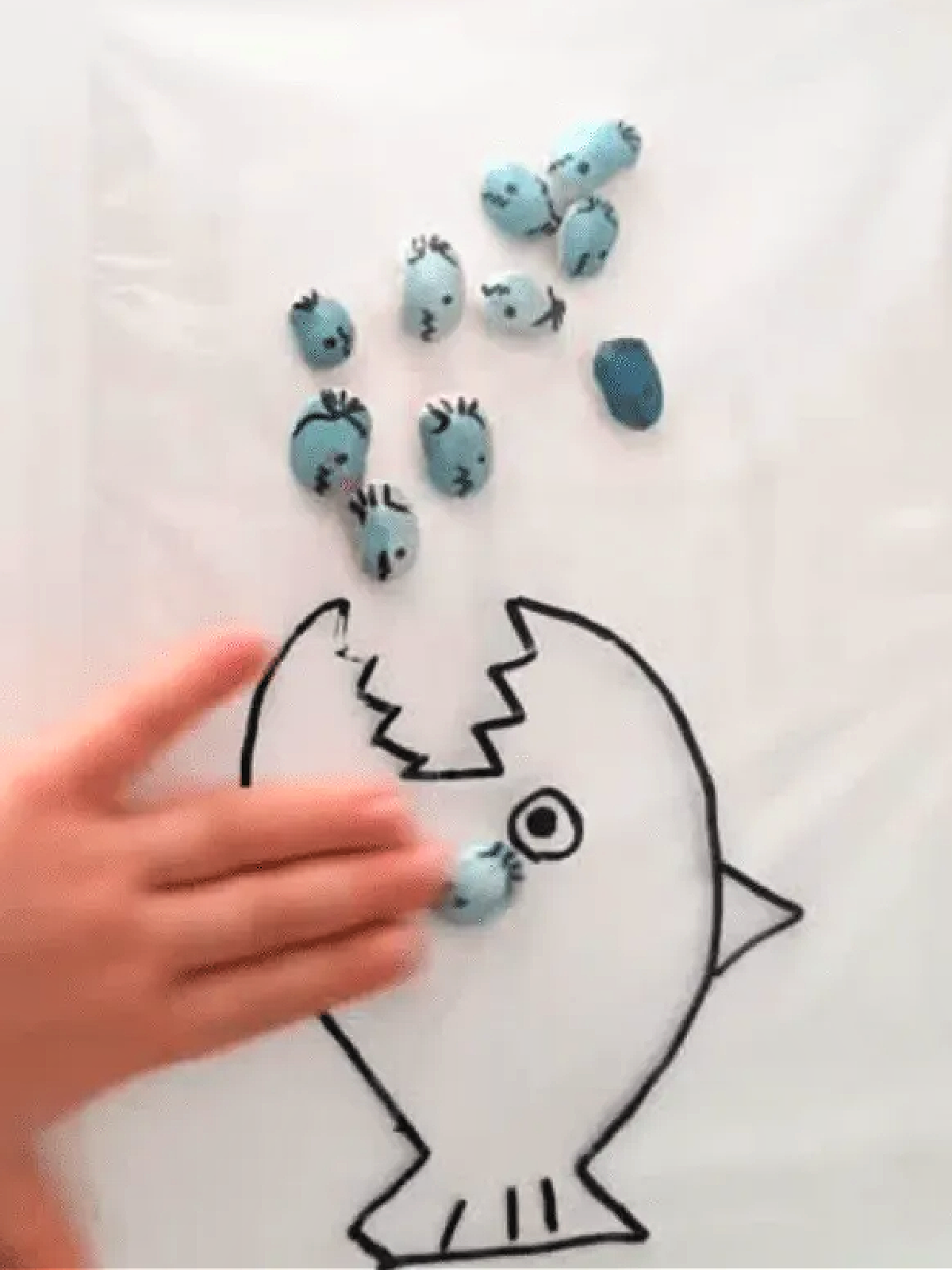 Shark Sensory Bag- Small baby sharks being fed to the big shark- kids activities blog