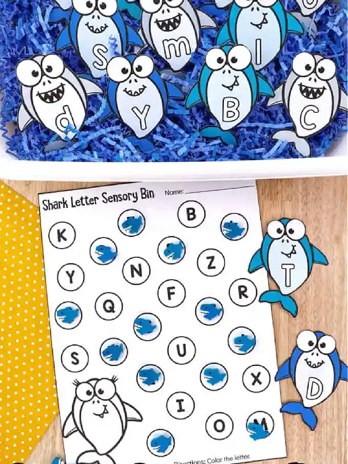 Shark Sensory Bin- blue paper, paper sharks, bin, wood table, and printables- kids activities blog