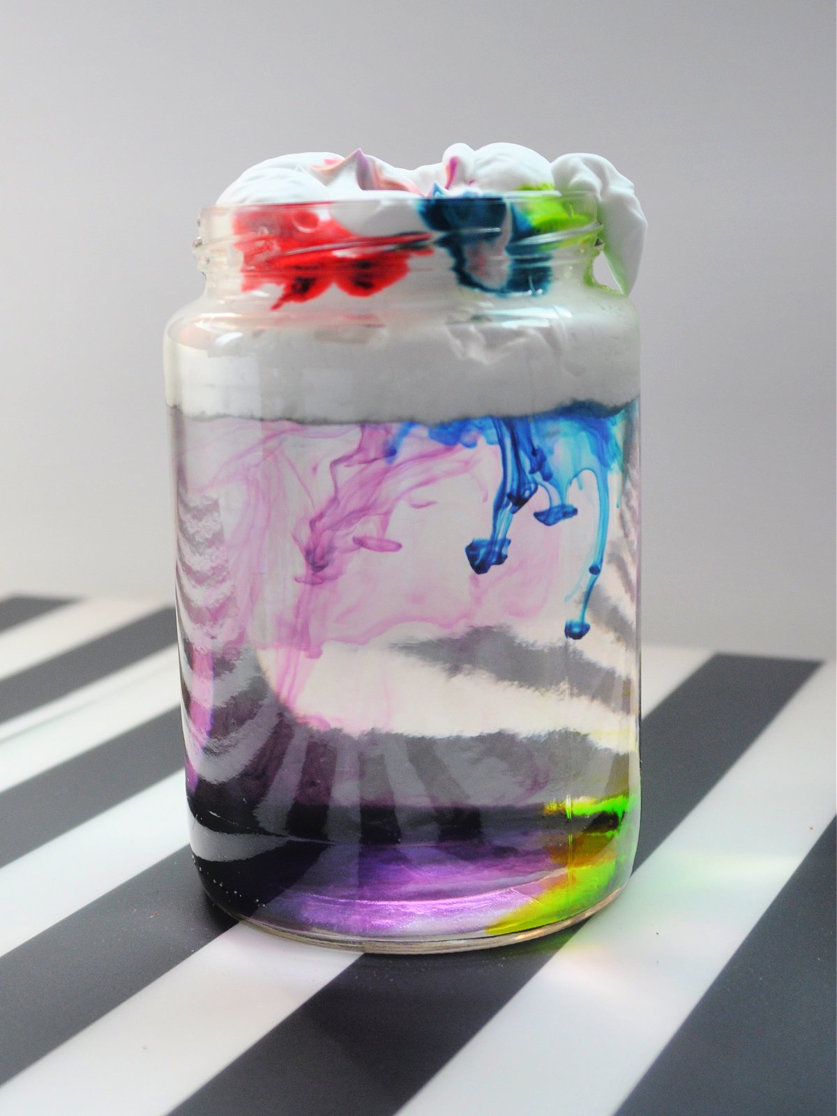 weather experiment- step 3- rain falling from clouds blue, purple, and green- kids activities blog