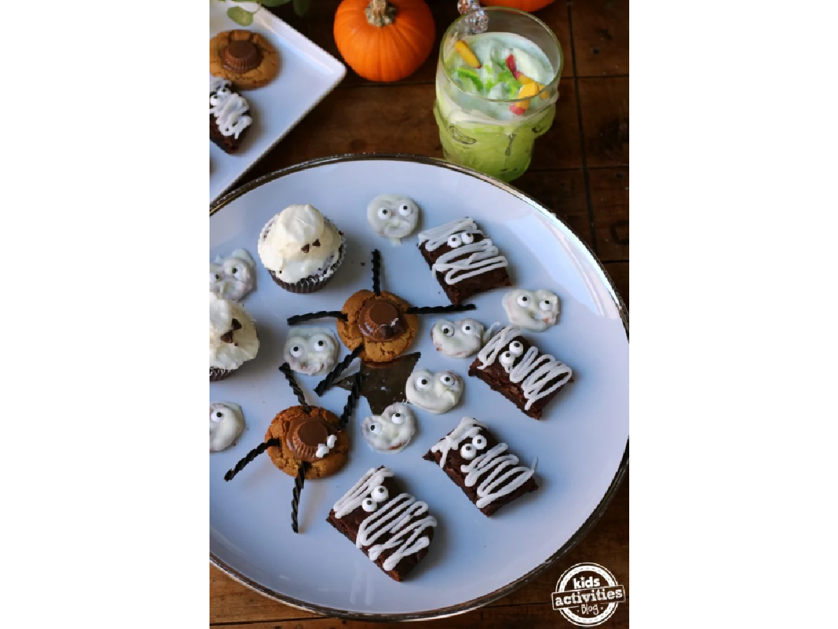 Halloween Recipes- Various sweets on a plate with a green drink on the side-Kids Activities Blog