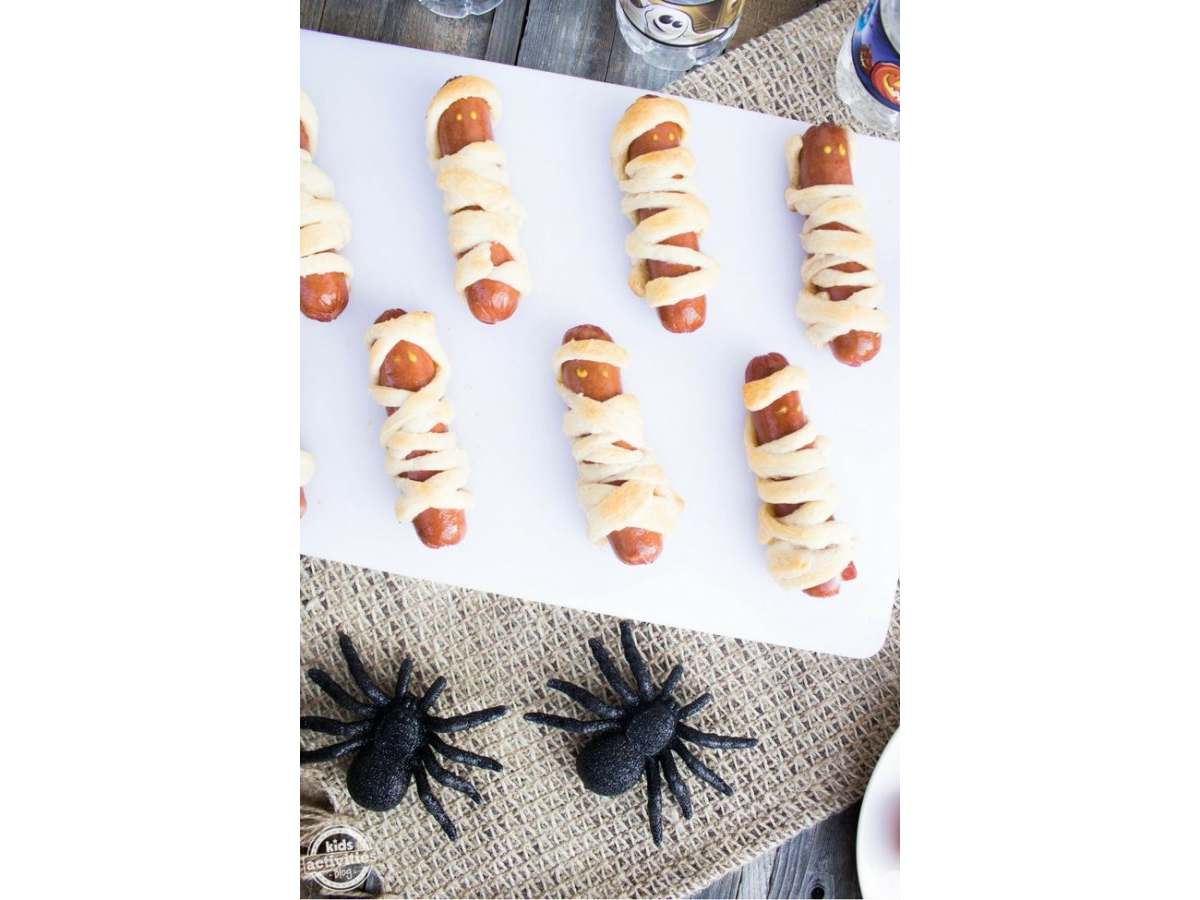 Halloween Recipes- Hot dogs wrapped in dough to look like a mummy with spooky decor -Kids Activities Blog