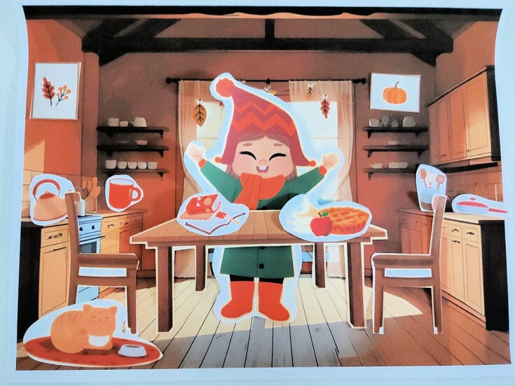 Fall Printable- Completed printable of a kitchen cabin background with accessories put in with a girl, table, chair, and food- kids activities blog