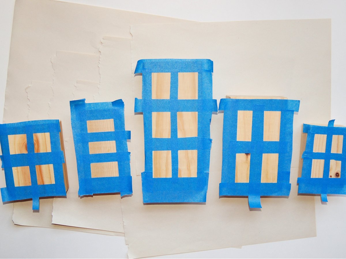Wooden Town Blocks- Step 2- Tape off windows on your blocks with blue painters tape- Kids Activities Blog