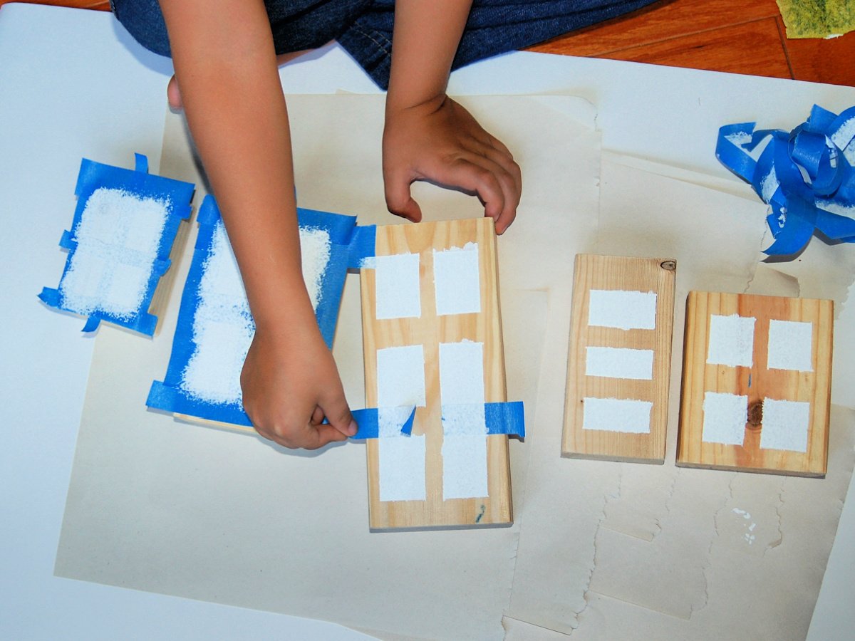 Wooden Town Blocks- Step 4- Once your windows are dry, child begins peeling the painters tape- Kids Activities Blog