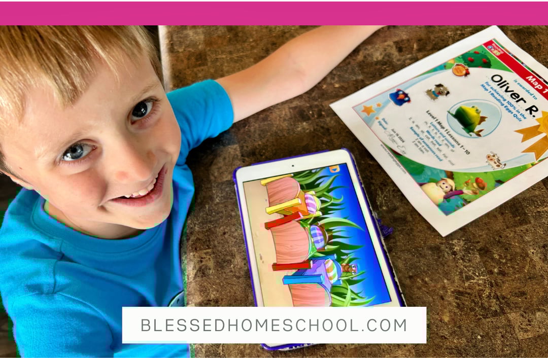 school age boy using an ipad and printable from Reading Eggs Homeschool Max curriculum sitting at a table looking into the camera
