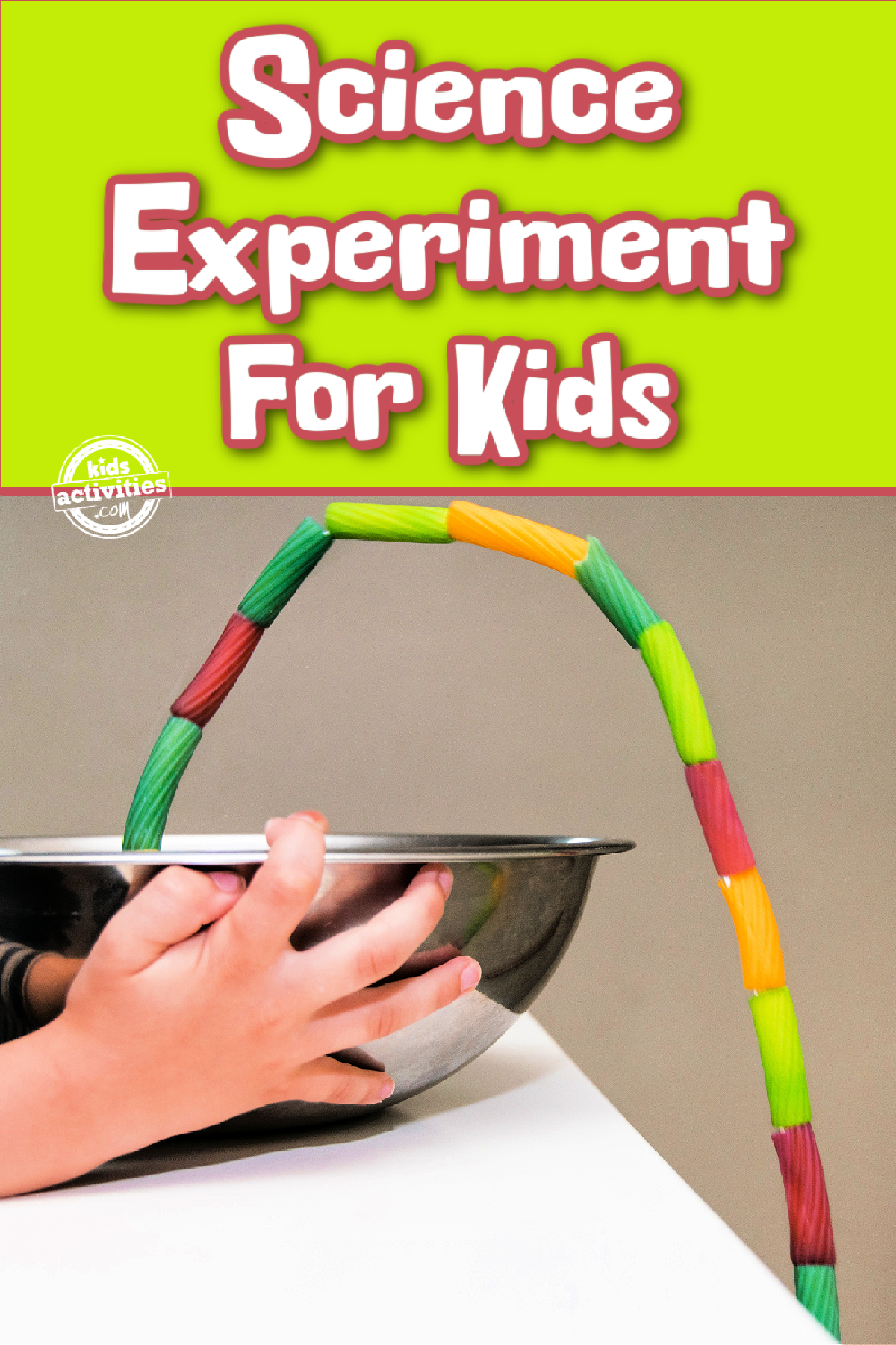 Pasta Fountain Science Experiment- colorful pasta spilling out of metal bowl held by child with text - Kids Activities Blog