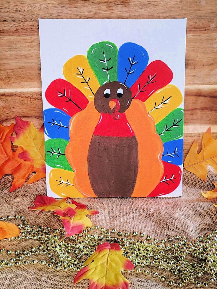Finished Thanksgiving Painting with canvas, colors, wood background, beads, and leaves as well as burlap.- kids activities blog
