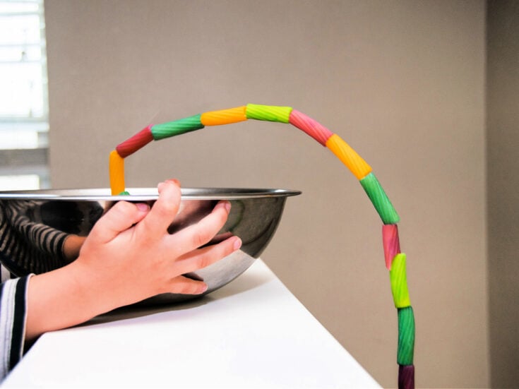 Pasta Fountain Science Experiment- step 3 - Pull out a couple inches of string and pasta - Kids Activities Blog