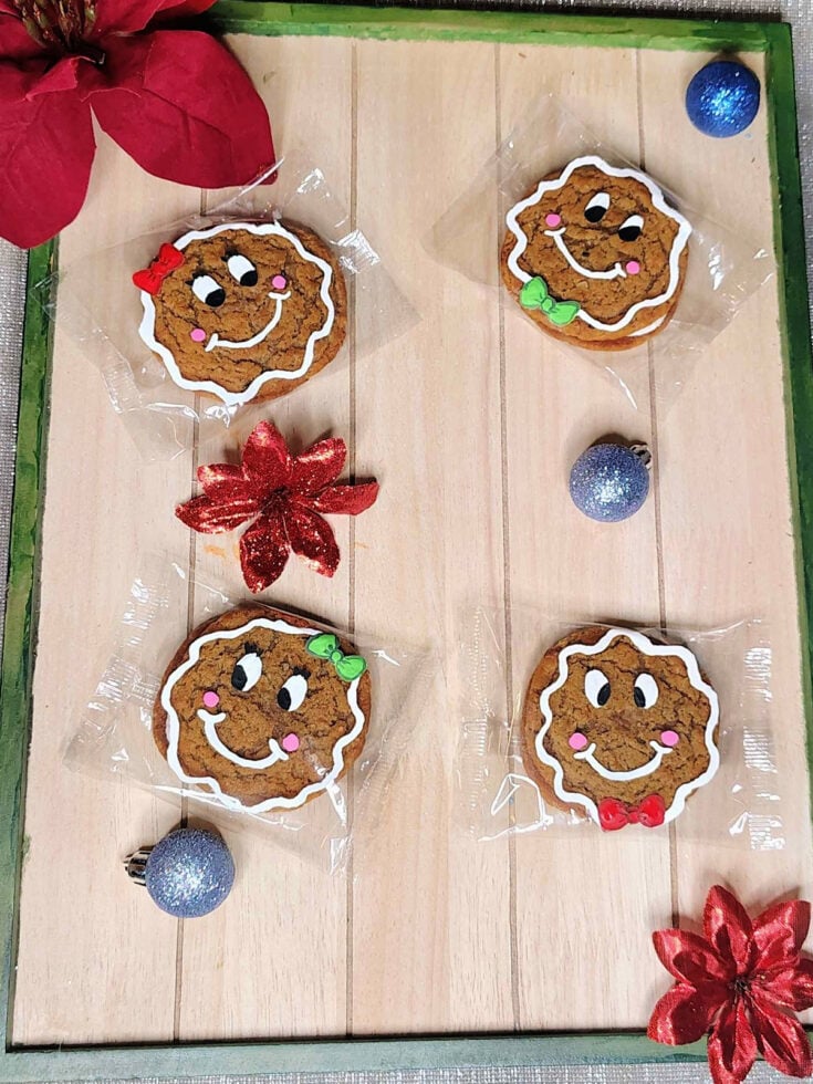 Gingerbread Man Craft- finished- painted cookies on wood with ornaments and flowers - Kids Activities Blog