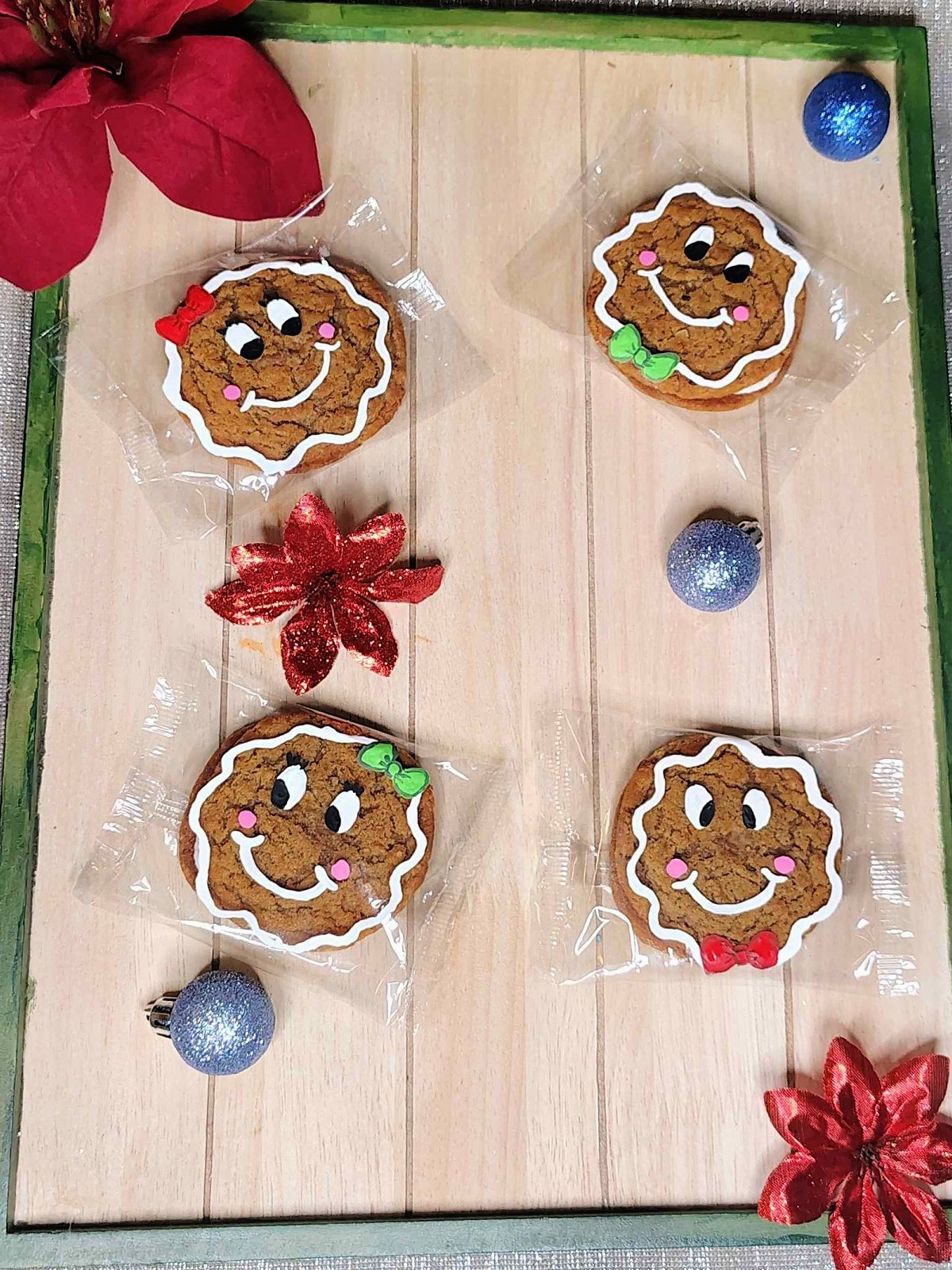 Gingerbread Man Craft- finished- painted cookies on wood with ornaments and flowers - Kids Activities Blog