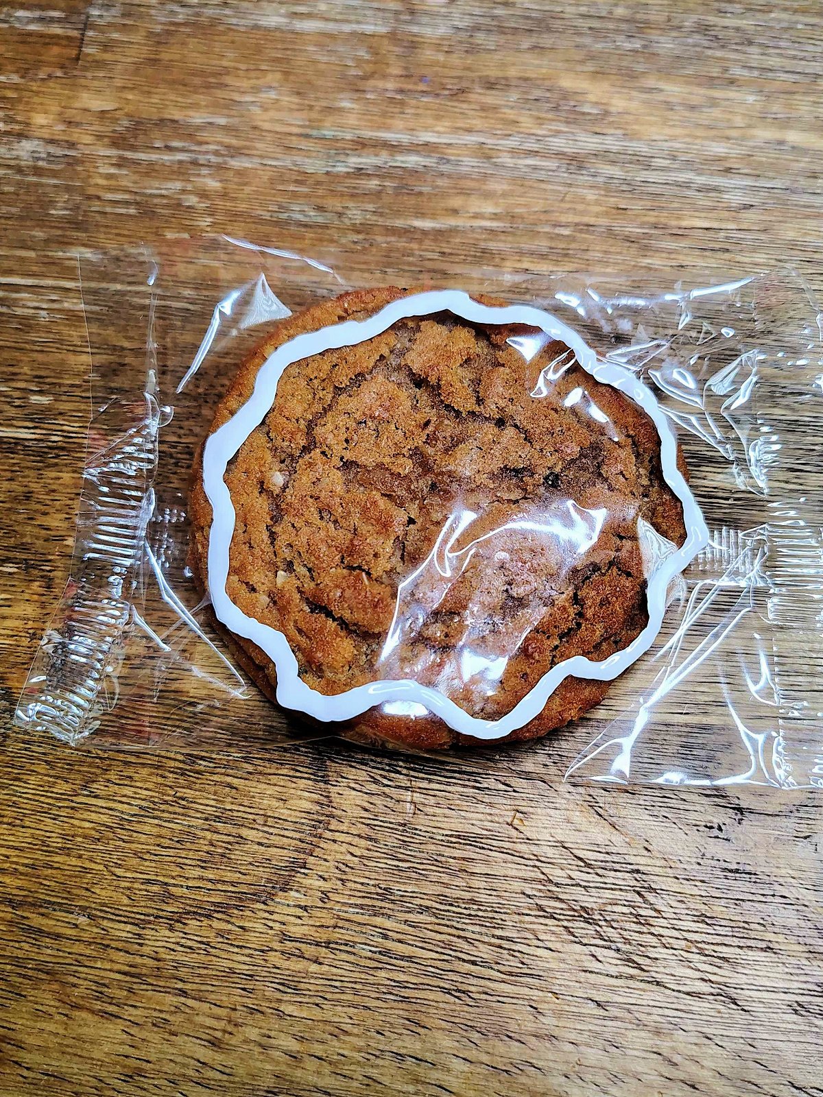 Gingerbread Man Craft- Step 1- White outline painted on cookie wrapper- Kids Activities Blog