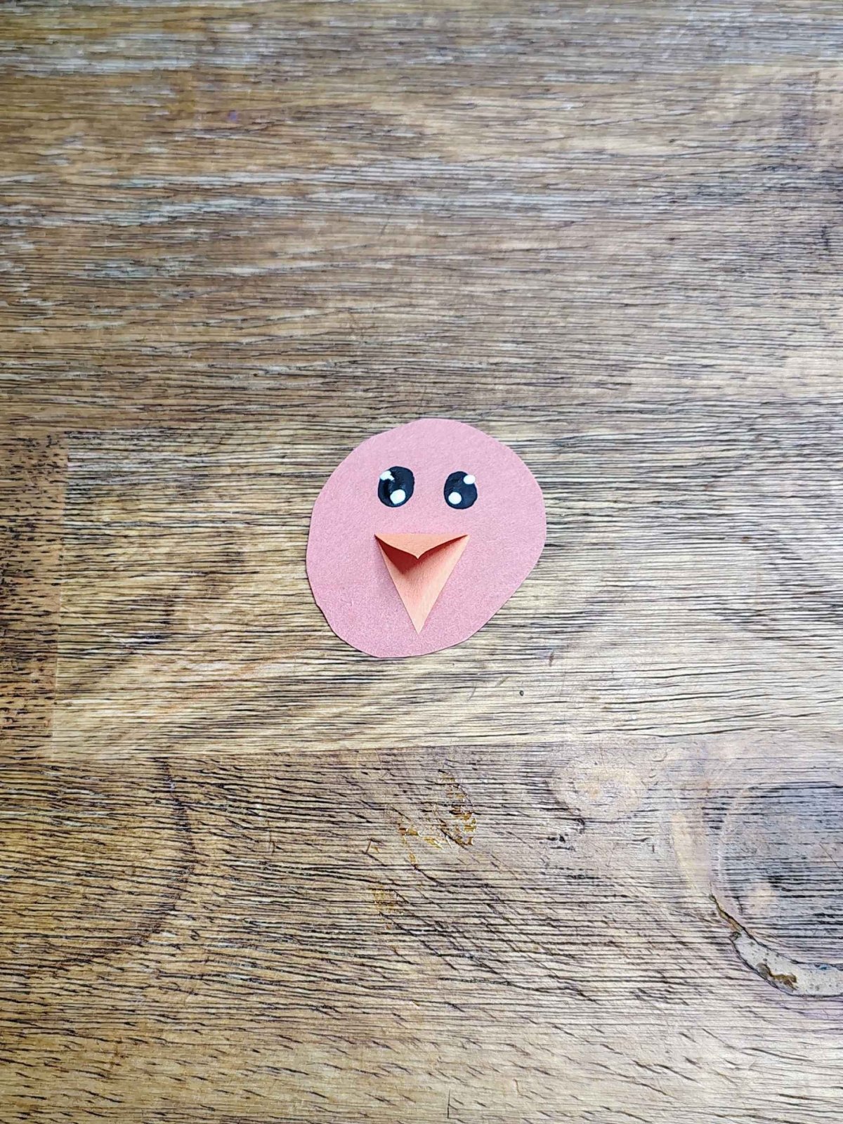 Turkey Craft- Step 2- eyes and beak added to the turkey's head- Kids Activities Blog