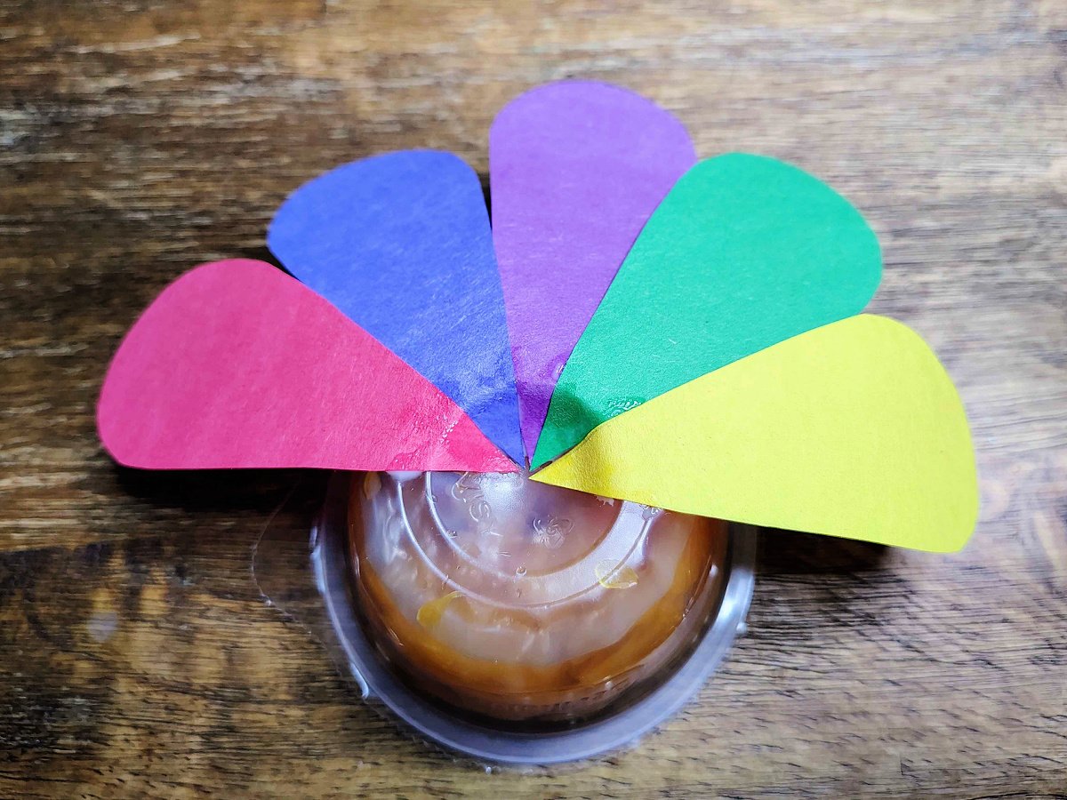 Turkey Craft- Step 4- Colorful strips of paper glued to oranges- Kids Activities Blog