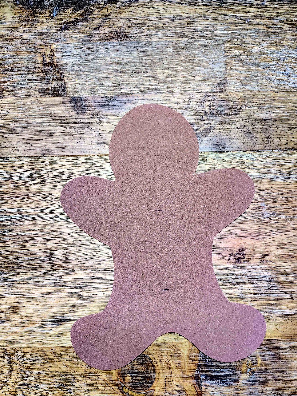 Candy Cane Holder Craft- Step 1- Slits cut into the gingerbread man - Kids Activities Blog