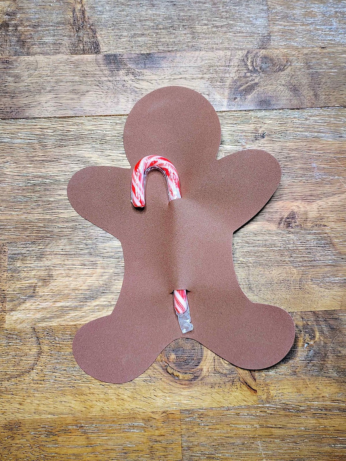 Candy Cane Holder Craft- Step 2- Candy Cane added to gingerbread man- Kids Activities Blog