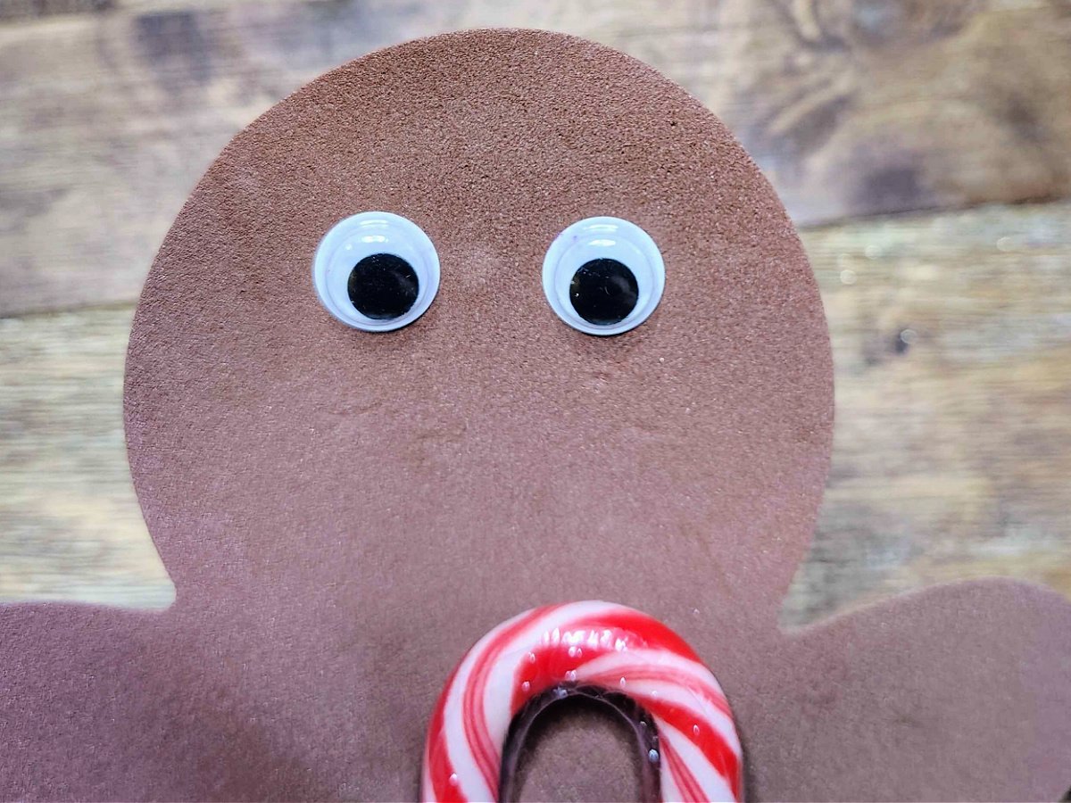 Candy Cane Holder Craft- Step 4- Googly eyes added to face - Kids Activities Blog