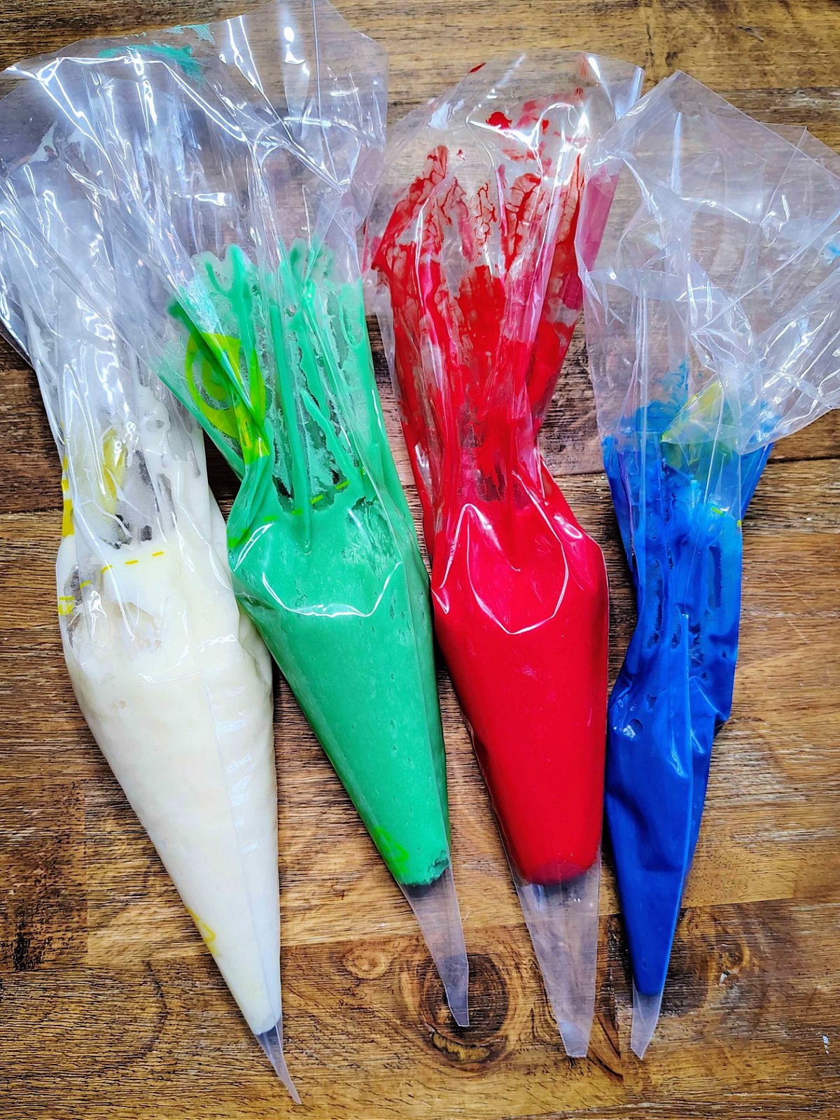 Christmas Brownies- Step 3- white, green, red, blue frosting in piping bags- Kids Activities blog