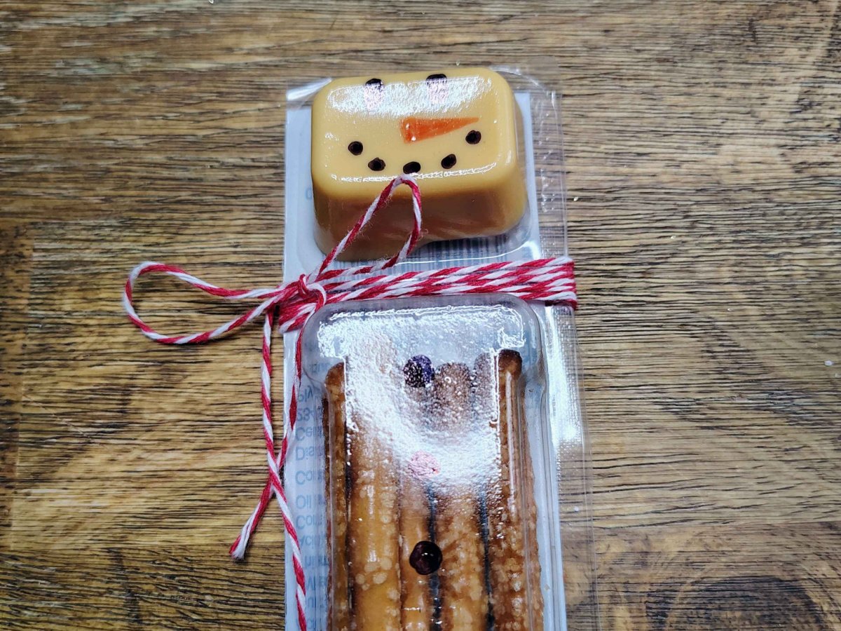 Christmas Snacks Craft- Step 5- Red and white string wrapped and tied as a scarf- Kids Activities Blog