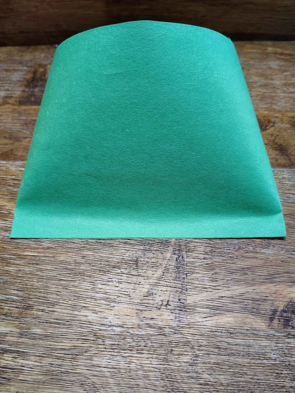 Christmas Tree Treat Bags- Step 4 - Press shut glue cylinder end - Kids Activities Blog