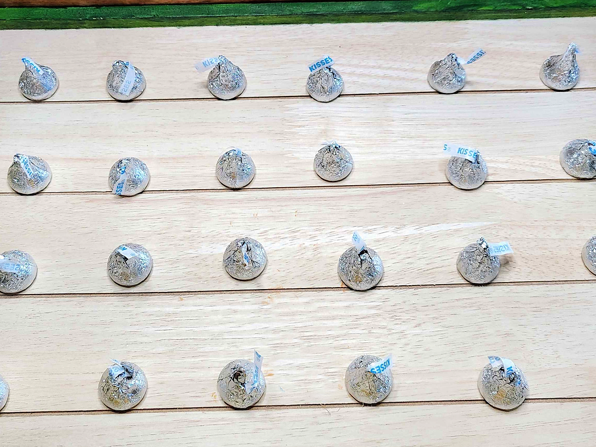 How To Play- Line up the hershey kisses in rows on wood board- kids activities blog