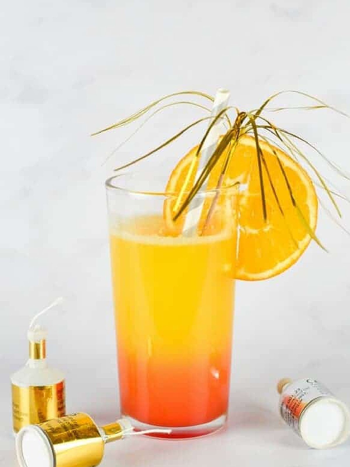 New Years Eve Mocktails- Sunrise with orange and yellow and poppers-Kids Activities Blog