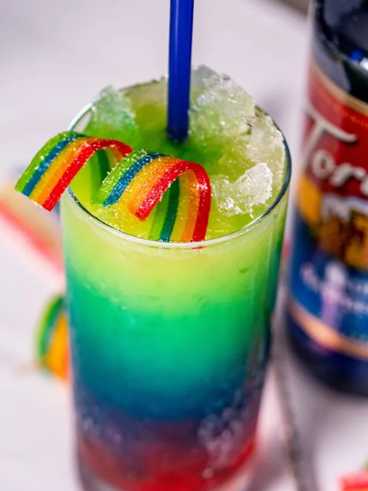 New Years Eve Mocktails- Rainbow drink with blue, green, yellow and rainbow candy -Kids Activities Blog