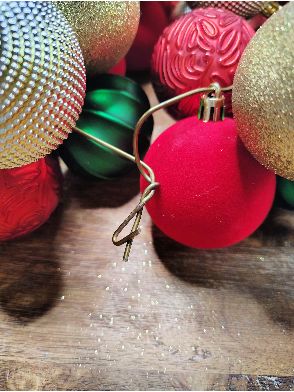 Christmas Ornament Wreath- Step 4- Metal hanger twisted at top- Kids Activities Blog