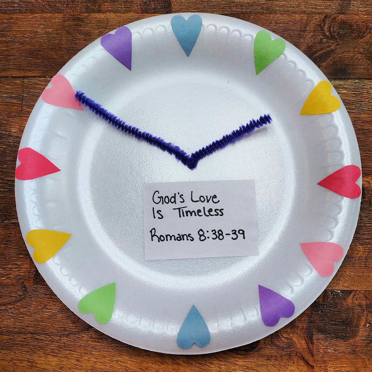 Bible Craft- Step 8 -Piece of paper with Bible verse glued on lower half of the paper plate clock - Kids Activities Blog