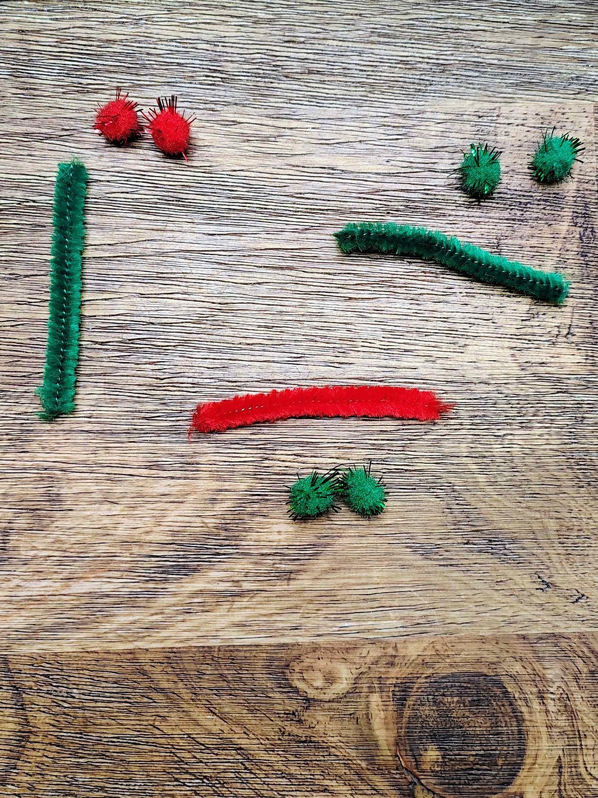 Snowman Craft- Step 2 - pipe cleaners and pom poms that are red and green- Kids Activities Blog