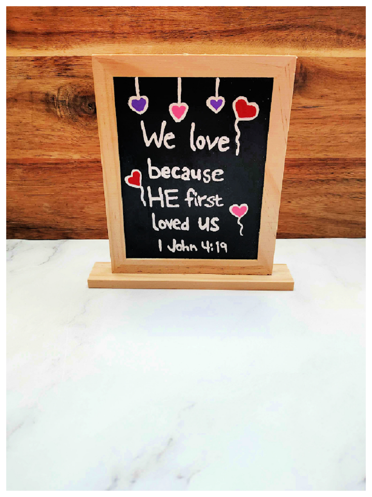Bible Valentine Craft- Finished- Chalkboard against a wood and white background with red purple and pink hearts and text - Kids Activities blog