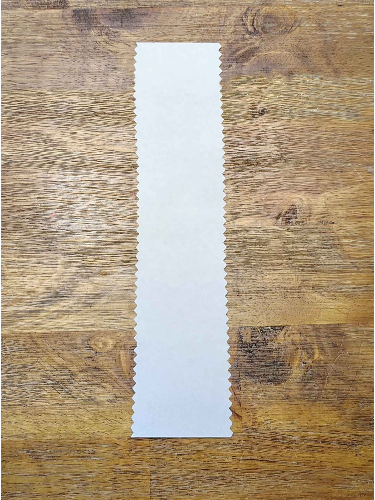 Bookmark Craft- Step 2 - Cut both sides of the bookmark with textured scissors - Kids Activities Blog