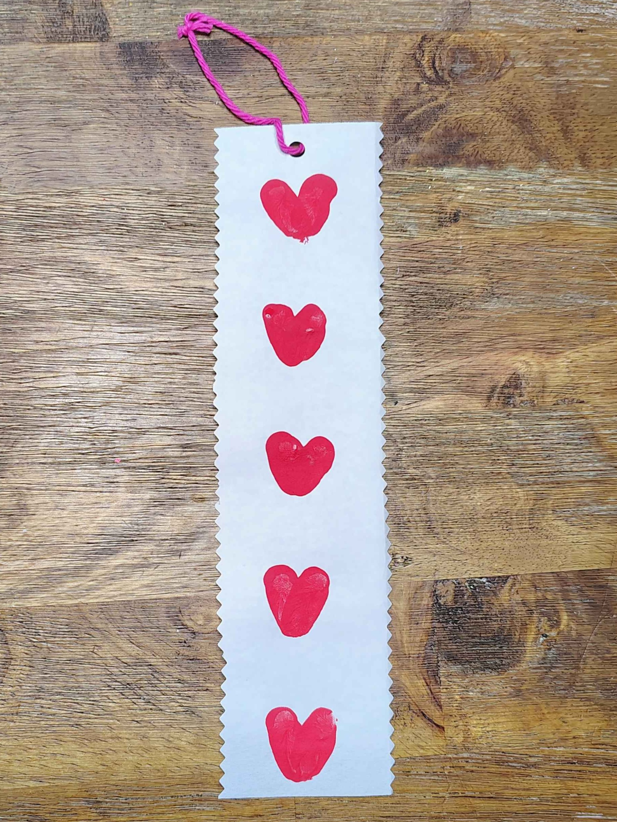 Bookmark Craft- Step 6- Add a pink string - Kids Activities Blog