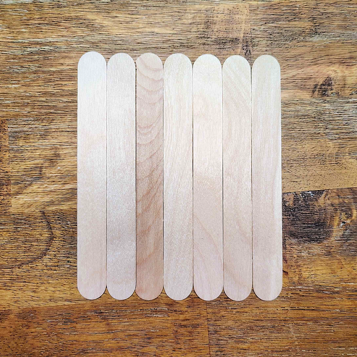 Valentine's Day Popsicle stick Craft- Step 1 - Jumbo popsicle sticks lined up- Kids Activities Blog