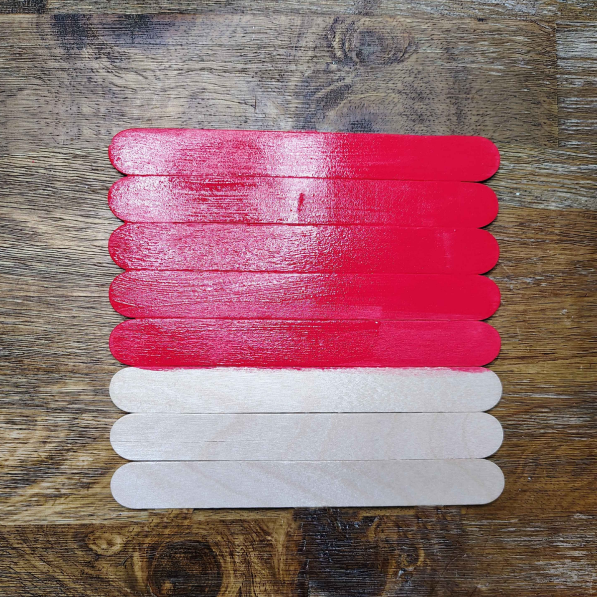 Valentine's Day Popsicle stick Craft- Step 3- Paint 3/4 of your popsicle sticks red- Kids Activities Blog