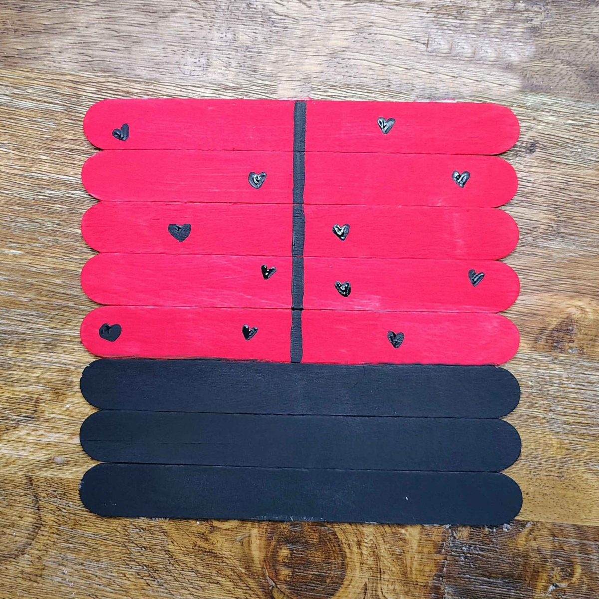 Valentine's Day Popsicle stick Craft- Step 6- Paint hearts on the red wings- Kids Activities Blog
