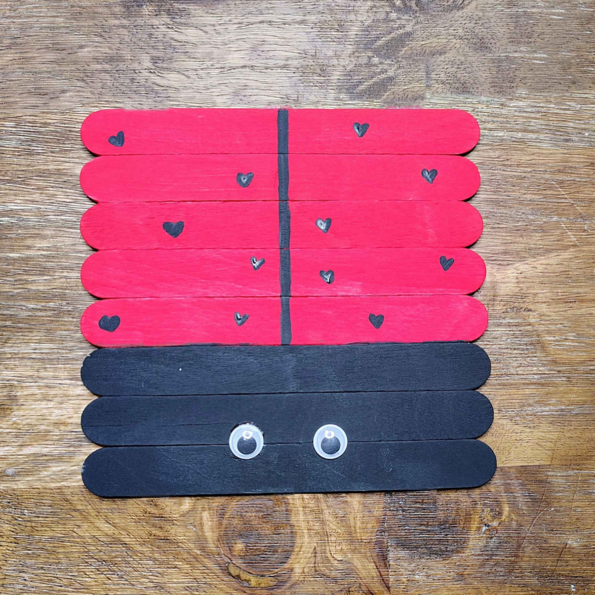 Valentine's Day Popsicle stick Craft- Step 7 - Glue on googly eyes - Kids Activities Blog