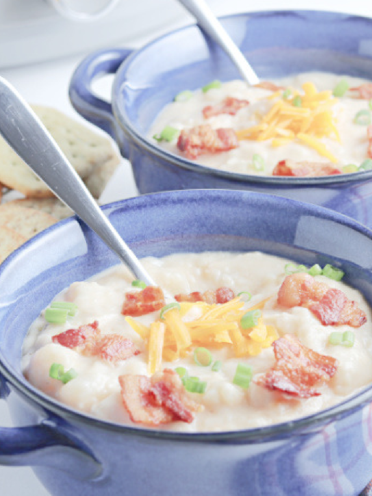 Sick Guide- Potato soup with bacon chives and cheese in blue bowls - Kids Activities Blog