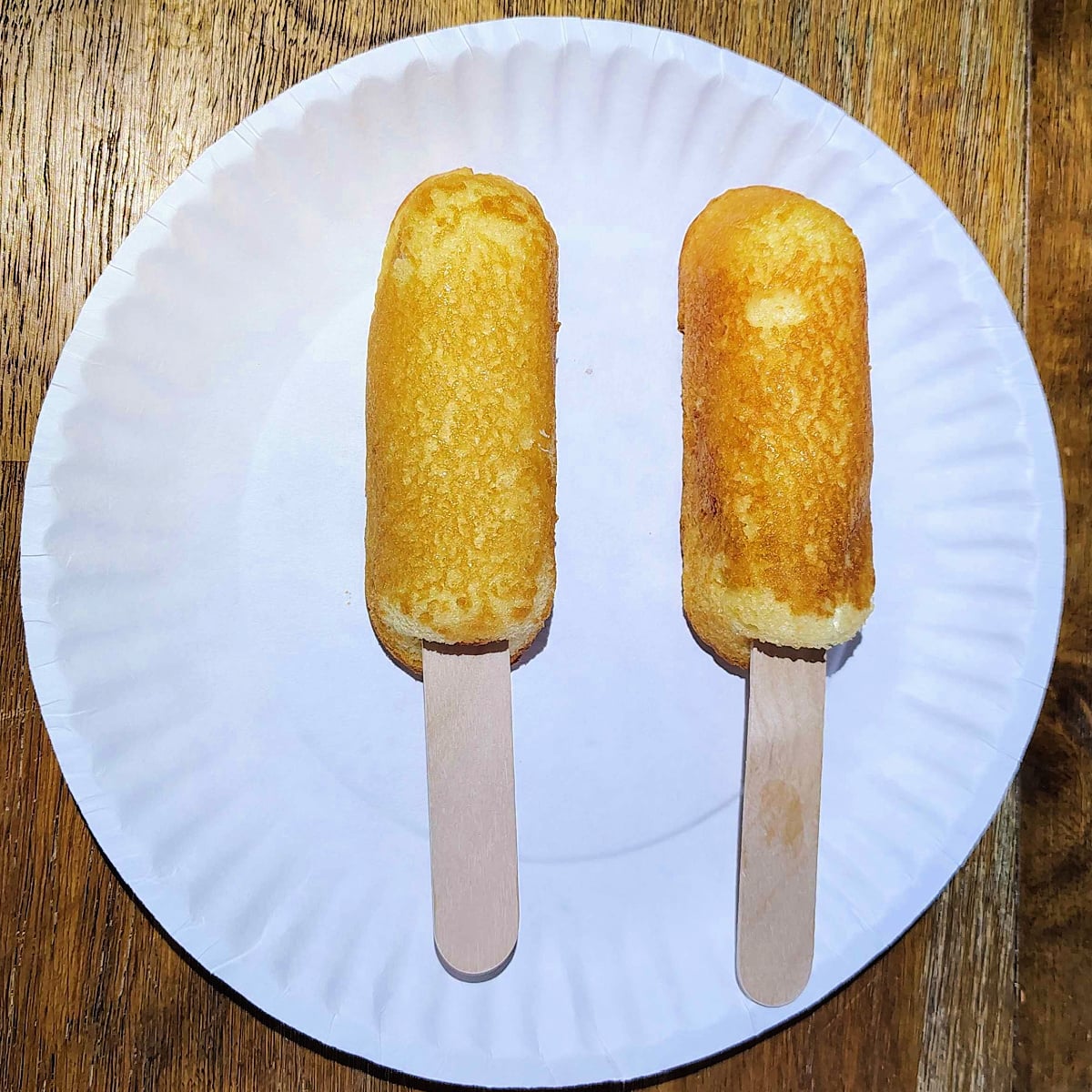 Twinkie Corn Dog- Step 3 - Twinkies on a plate with jumbo popsicle sticks -Kids Activities Blog