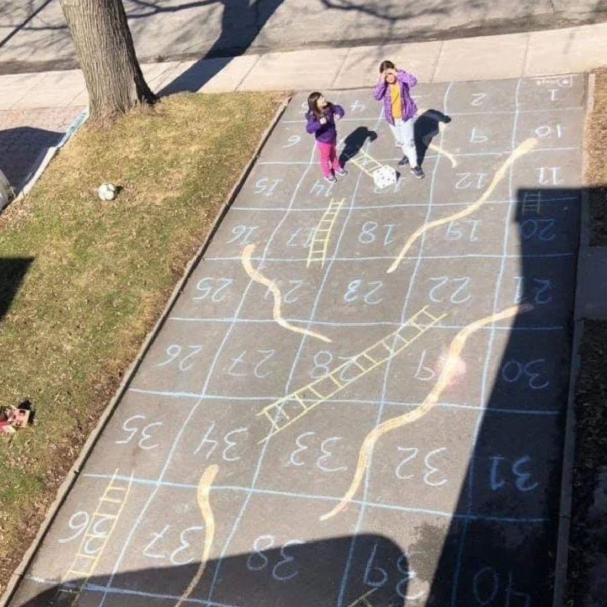 Earth Day Activities- kids playing outside with chalk- kids activities blog