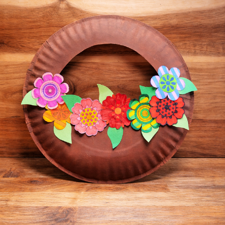 Flower basket craft- Finished flower basket against 2 wood surfaces - Kids Activities Blog
