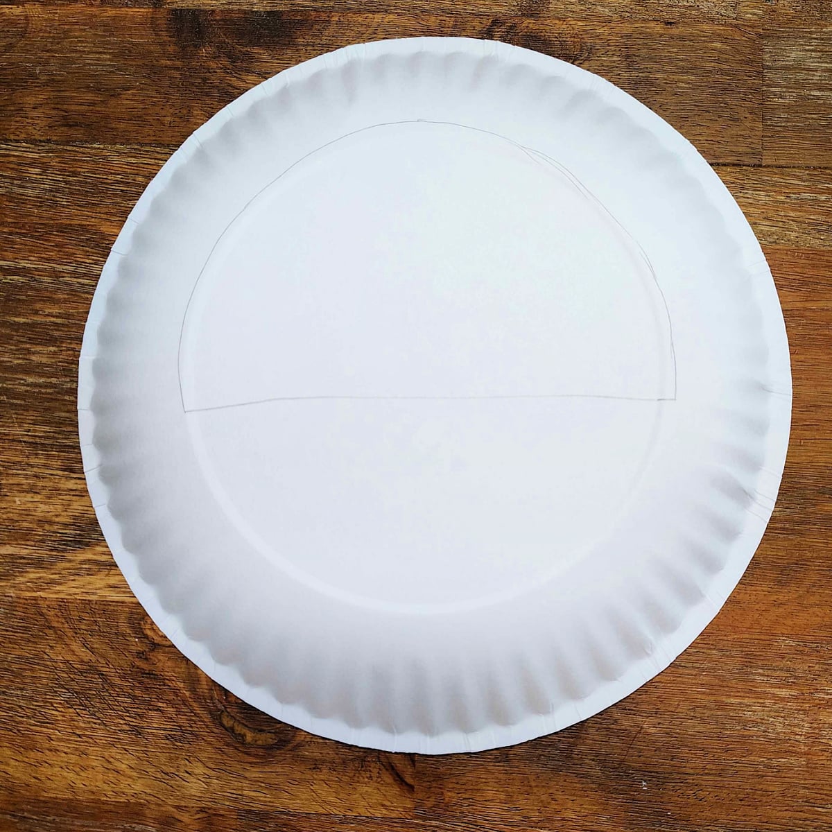Flower basket craft- Step 2 - Trace dome on top of paper plate- Kids Activities Blog