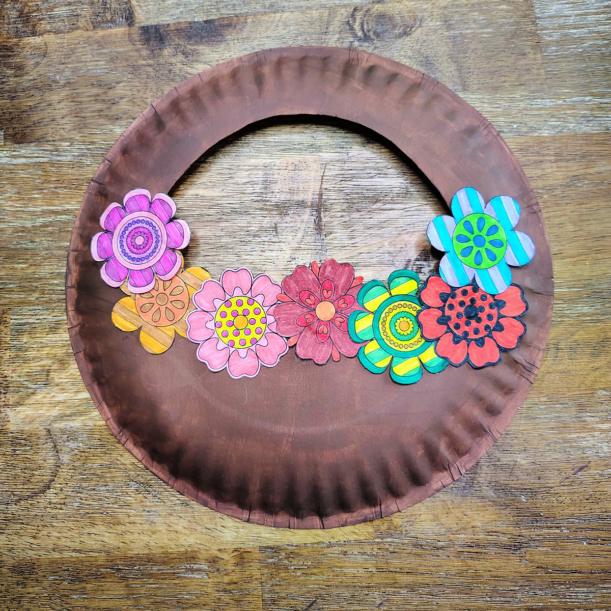 Flower basket craft- Step 5- Glue flowers to brown- Kids Activities Blog